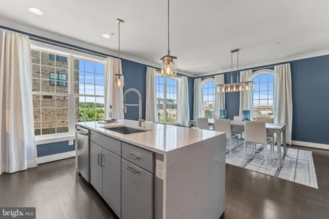 a large kitchen with kitchen island granite countertop a large window in it