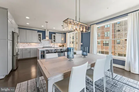a kitchen with kitchen island a table and chairs in it