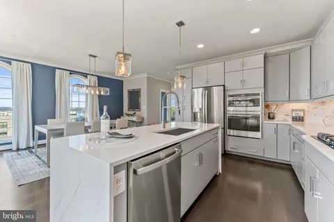 a kitchen with a sink stove and refrigerator