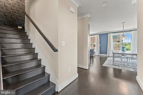 a view of entryway and hall with wooden floor
