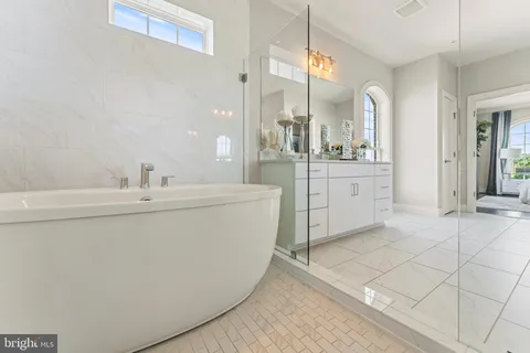 a spacious bathroom with a sink a mirror and a bathtub