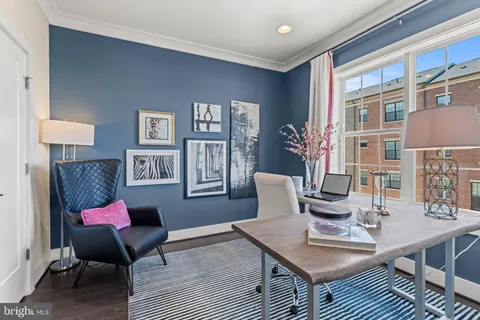 a living room with furniture a rug and a table