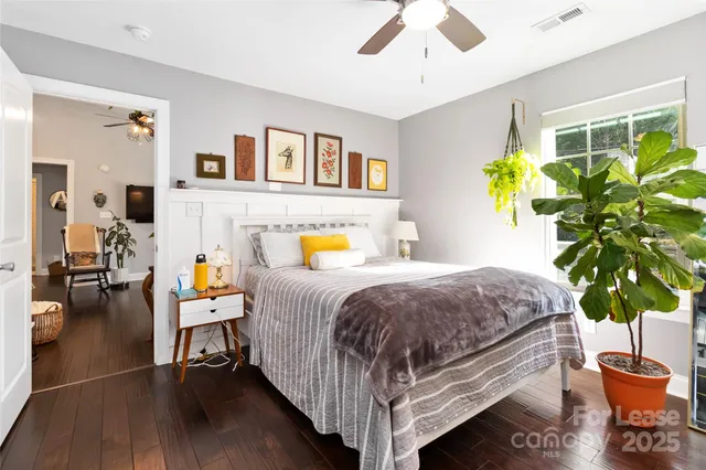 a bedroom with a bed and a potted plant