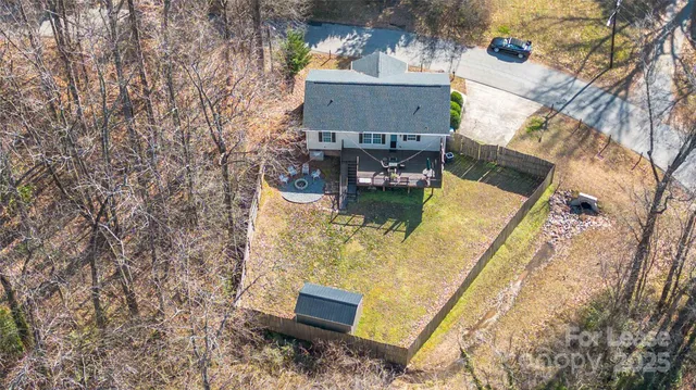 an aerial view of a house with balcony and trees