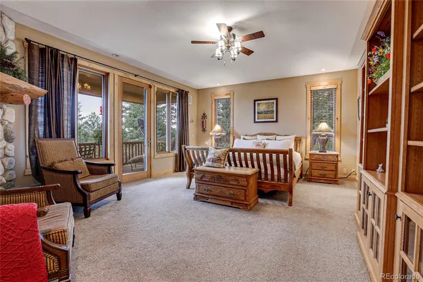a spacious bedroom with a bed and a chandelier