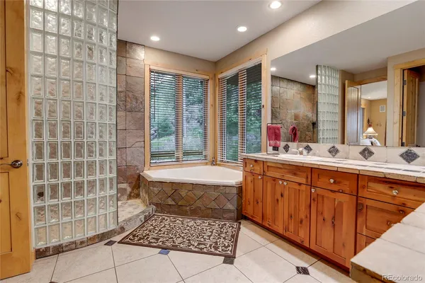 a bathroom with a sink mirror and shower