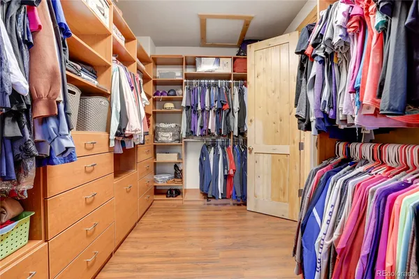 a view of walk in closet with clothes