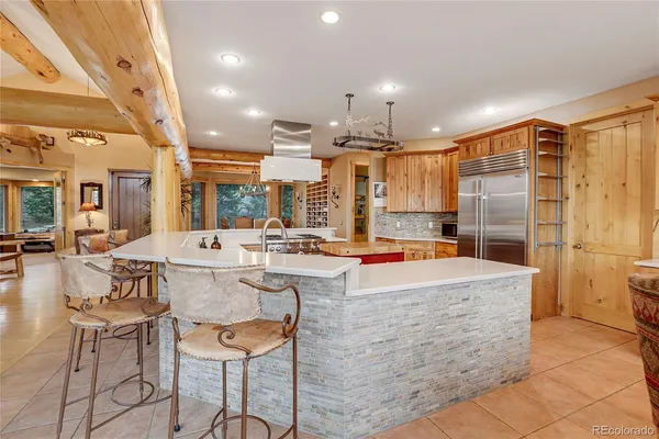 a large kitchen with a table and chairs