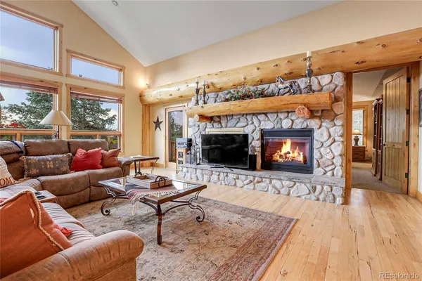 a living room with furniture flat screen tv and a fireplace