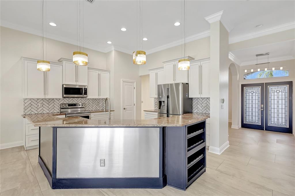 2863 Duncan Tree Circle Valrico, FL 33594 - Photo 25 of 53 a large kitchen with stainless steel appliances granite countertop a stove and cabinets
