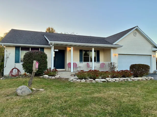 a front view of house with yard and outdoor seating