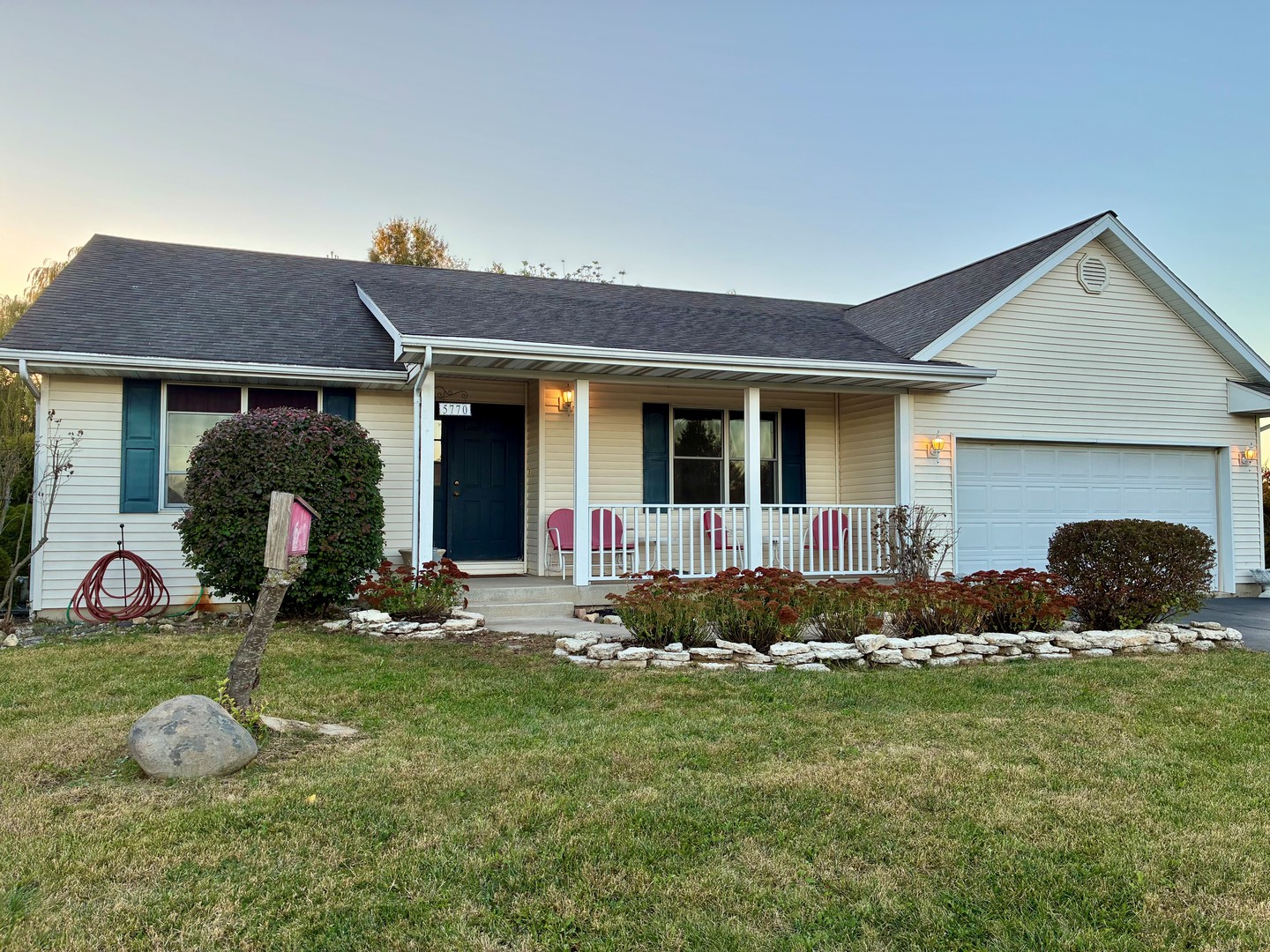 a front view of house with yard and outdoor seating