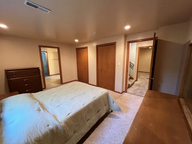 a bedroom with a bed and a dresser