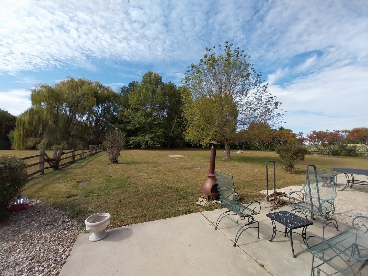 5770 South Indian Trail Rochelle, IL 61068 - Photo 18 of 21 a view of a lake with couches and wooden fence