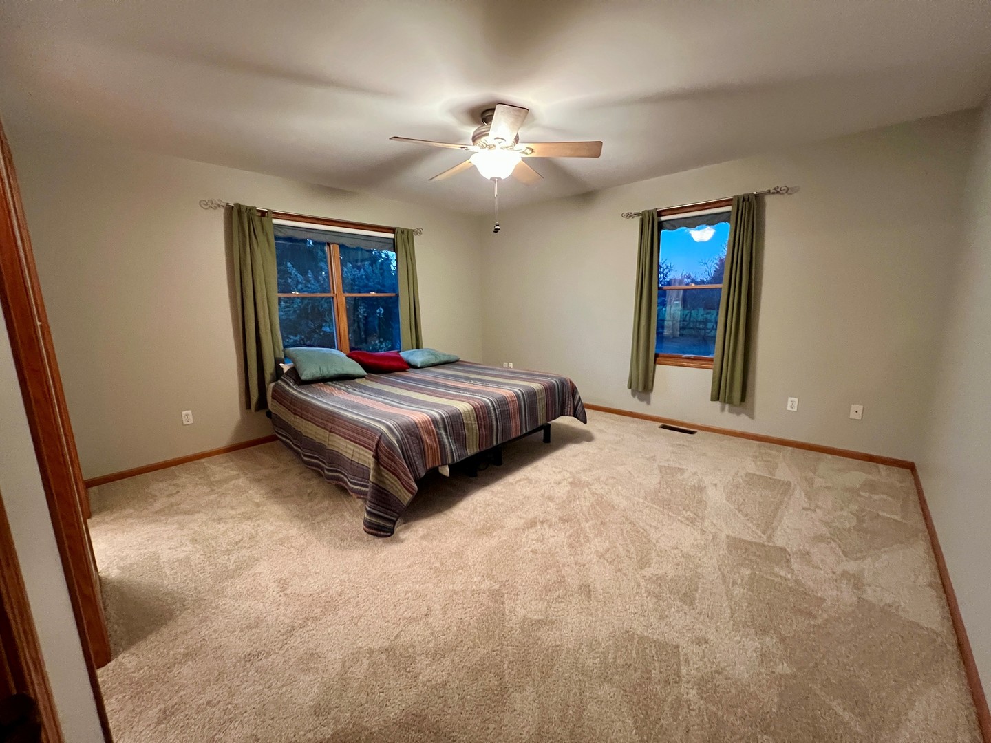 5770 South Indian Trail Rochelle, IL 61068 - Photo 7 of 21 a bedroom with a large bed and a chandelier