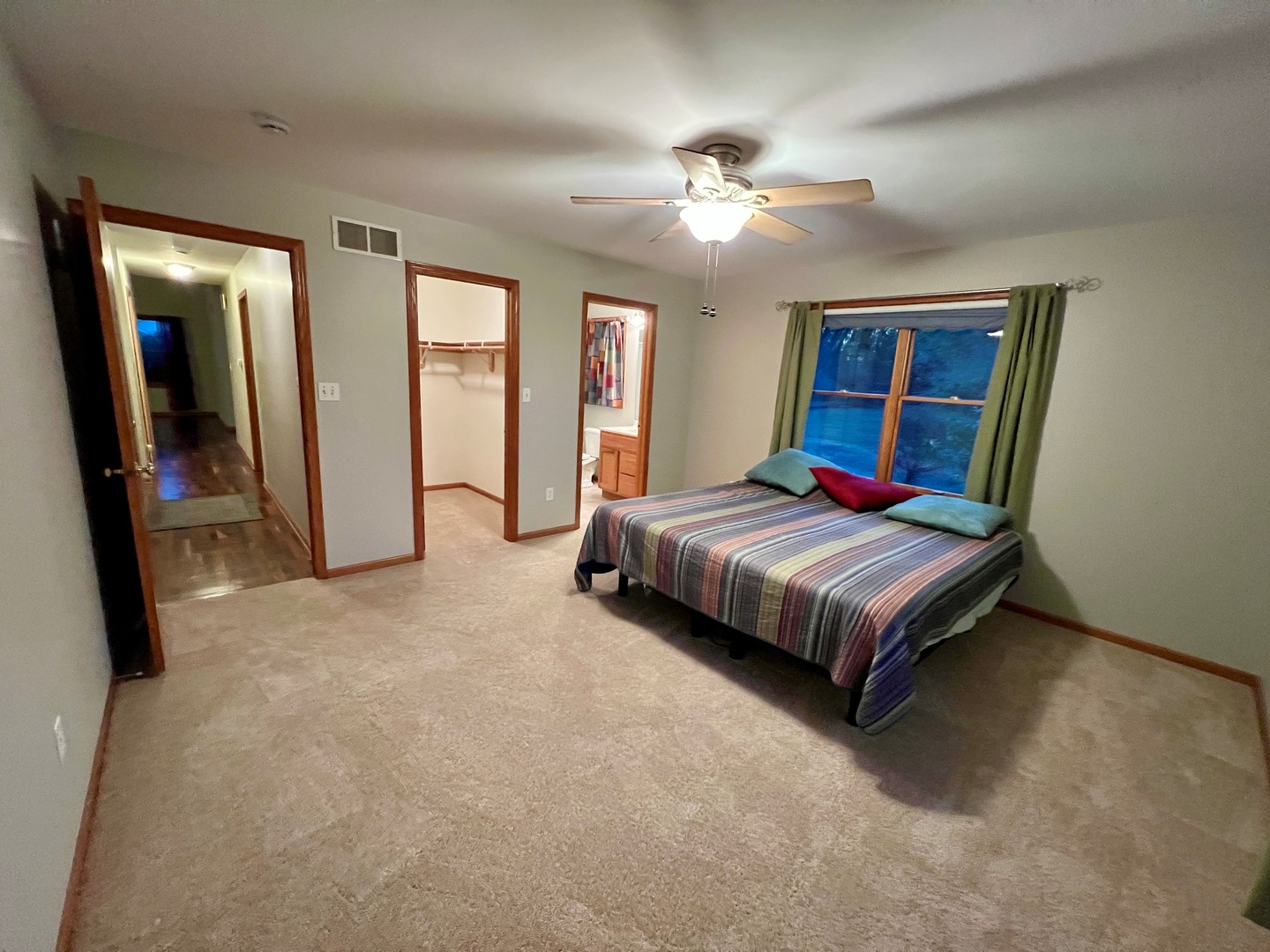 5770 South Indian Trail Rochelle, IL 61068 - Photo 8 of 21 a bedroom with a large bed and a chandelier