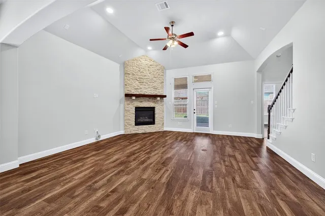 wooden floor in an empty room with a fireplace