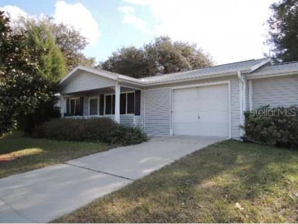 8090 Southwest 109 Street Road Ocala, FL 34481 - Photo 1 of 1 a view of a house with a yard and garage