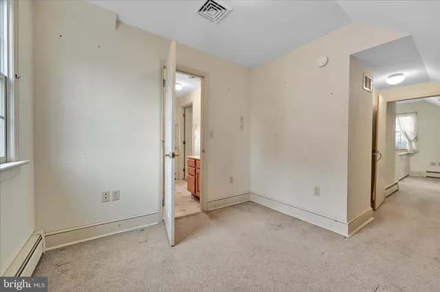 an empty room with mirror in it