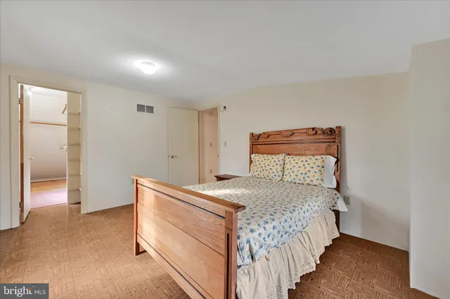 a bedroom with a bed and a lamp