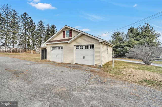 a view of a house with a backyard and trees