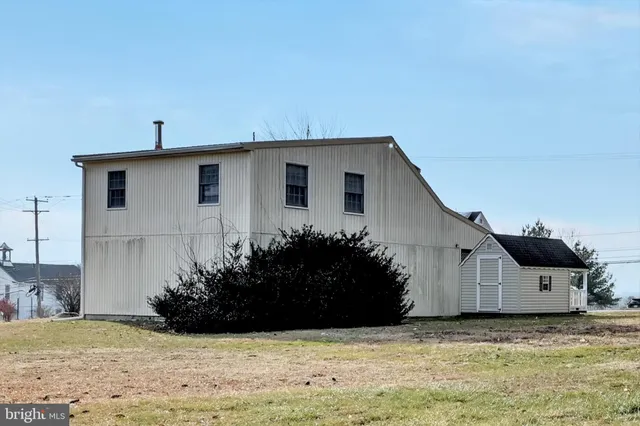 a view of large space with a house in the background