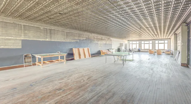 a large room with wooden floor and furniture