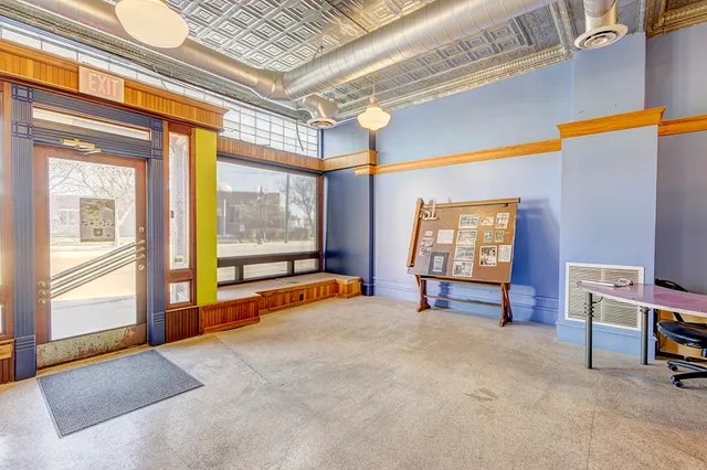 a view of a workspace with furniture and a window