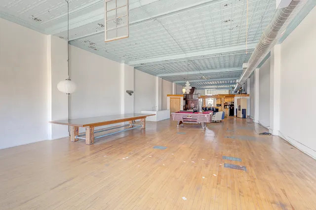 a view of a room with table and chairs