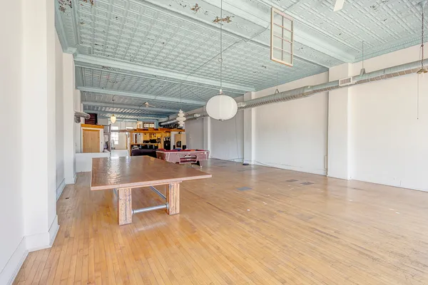 a view of a room with wooden floor