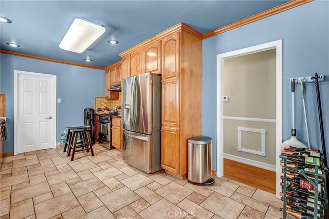 a view of a refrigerator and chair in a room