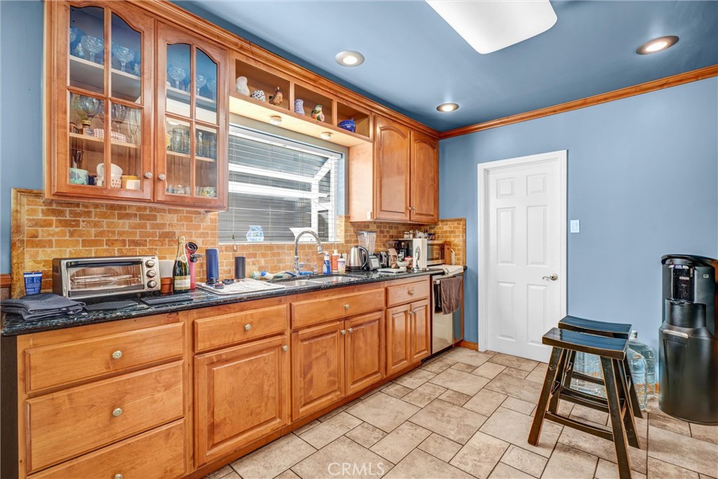 4816 Stratford Road Los Angeles, CA 90042 - Photo 16 of 20 a kitchen with granite countertop sink cabinets and window