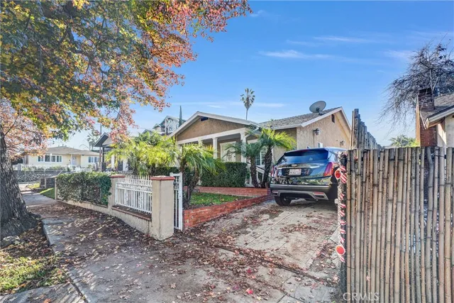 a view of a house with a yard and sitting area