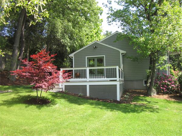 40 Grace Road Newton, MA 02459 - Photo 5 of 24 a front view of a house with a garden and yard