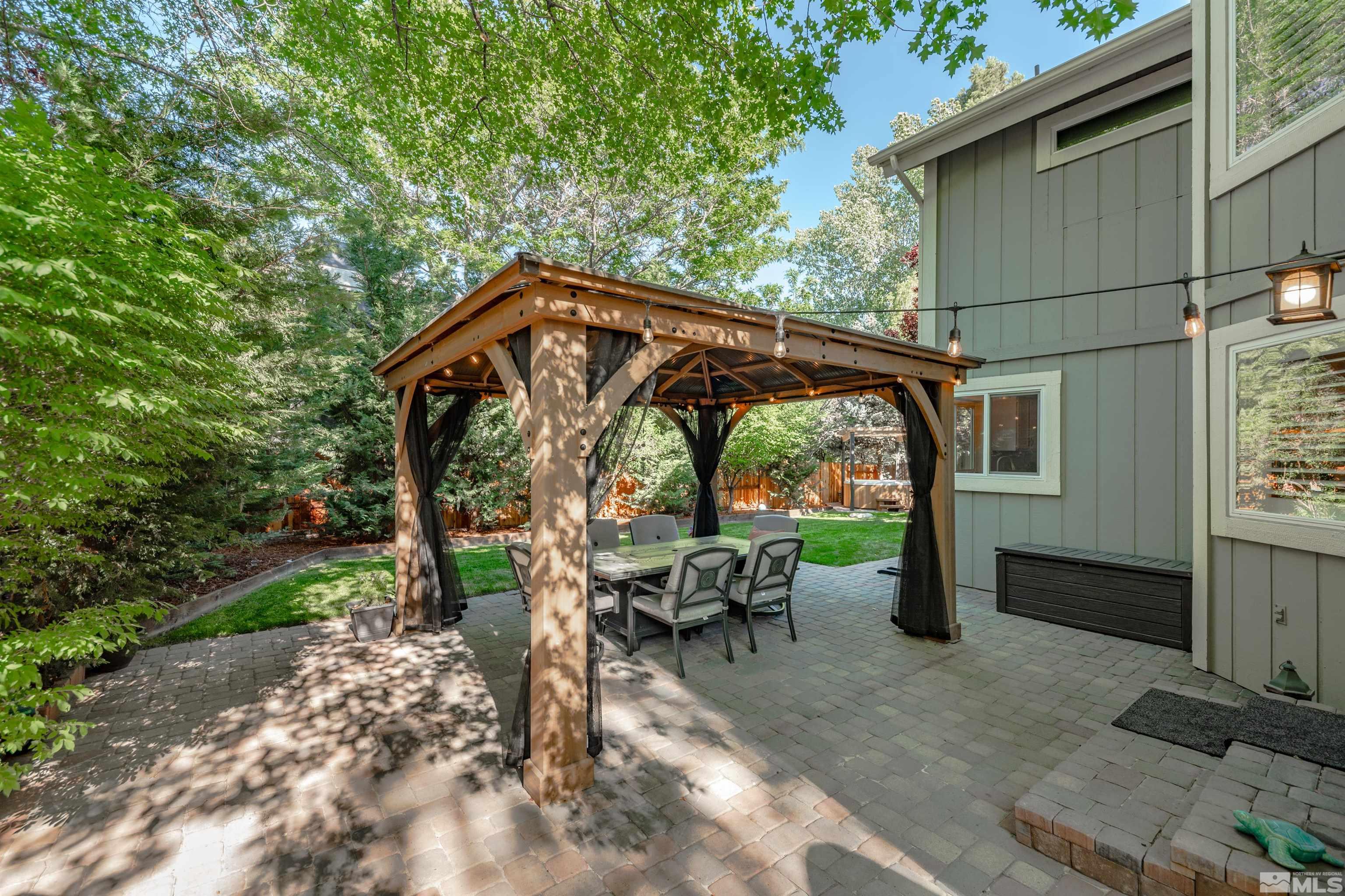 110 Riverhaven Place Reno, NV 89519 - Photo 31 of 40 a view of backyard with a table and chairs under an umbrella