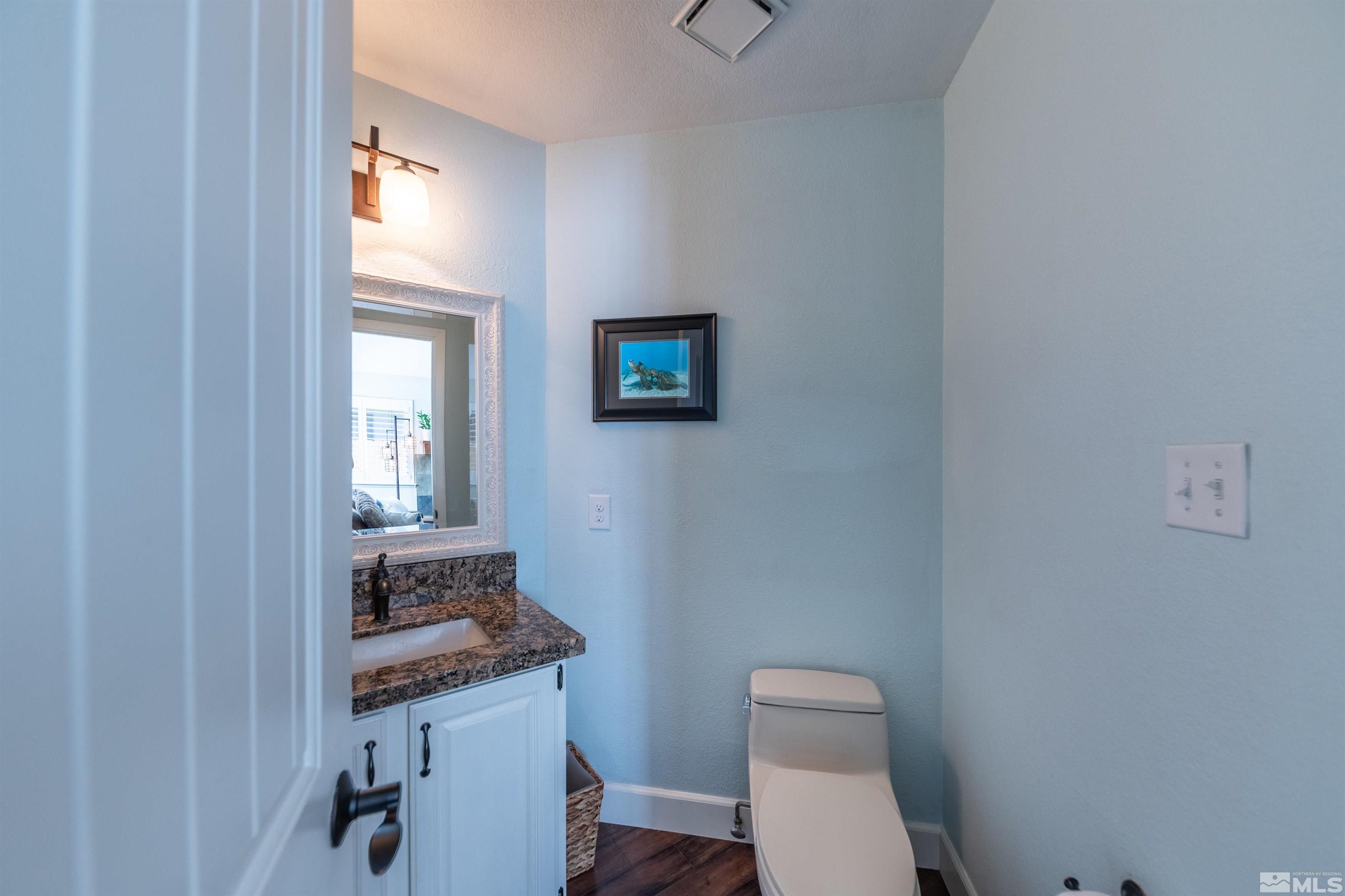 110 Riverhaven Place Reno, NV 89519 - Photo 40 of 40 a bathroom with a toilet a sink and mirror