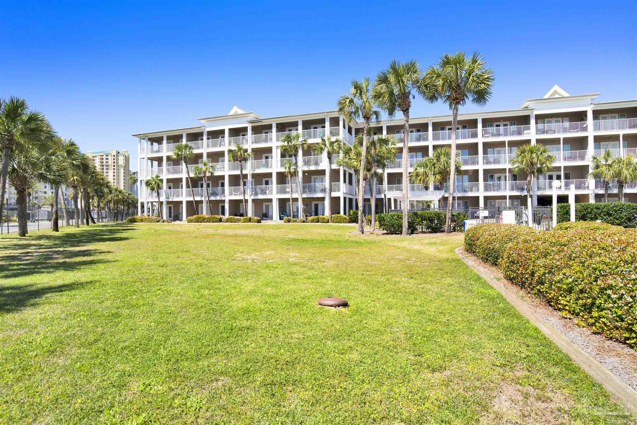 13351 Johnson Beach Road, Unit 203E Perdido Key, FL 32507 - Photo 42 of 55 a front view of a building with a garden