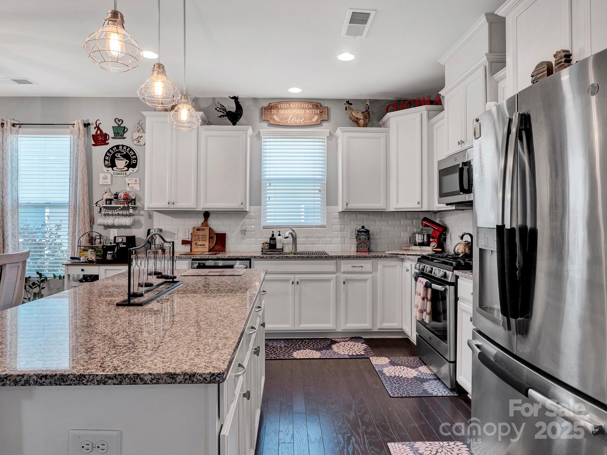 3129 Bridgewater Street, Unit 3E61 Lancaster, SC 29720 - Photo 12 of 48 a kitchen with stainless steel appliances granite countertop a sink stove and refrigerator