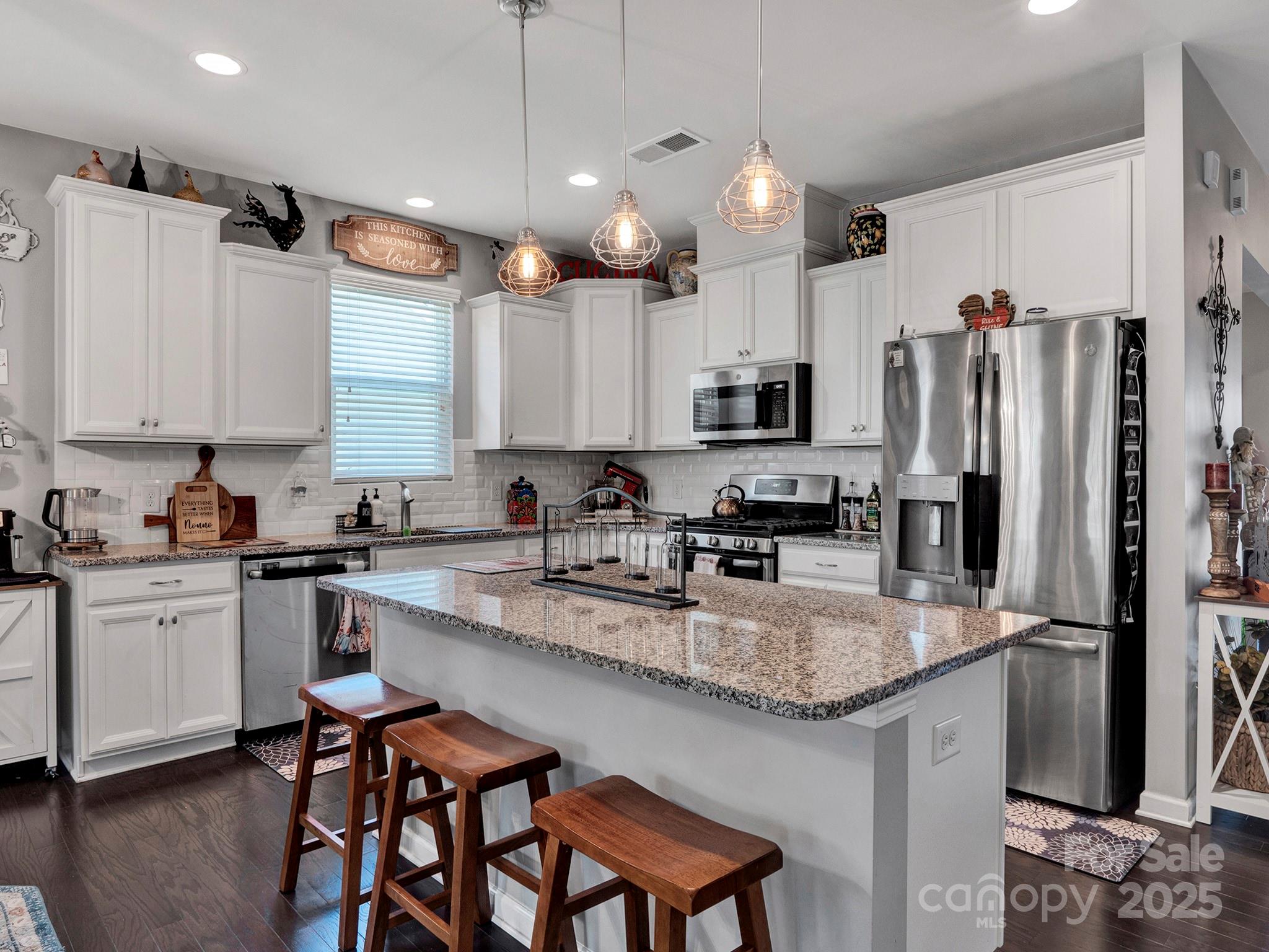 3129 Bridgewater Street, Unit 3E61 Lancaster, SC 29720 - Photo 14 of 48 a kitchen with stainless steel appliances granite countertop a sink refrigerator and cabinets