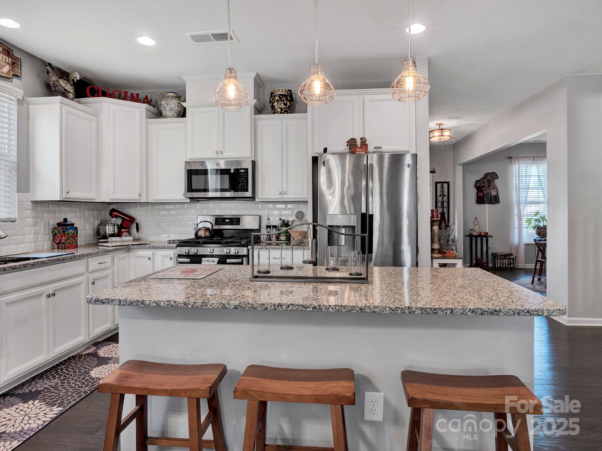 3129 Bridgewater Street, Unit 3E61 Lancaster, SC 29720 - Photo 16 of 48 a kitchen with stainless steel appliances granite countertop a sink and a refrigerator