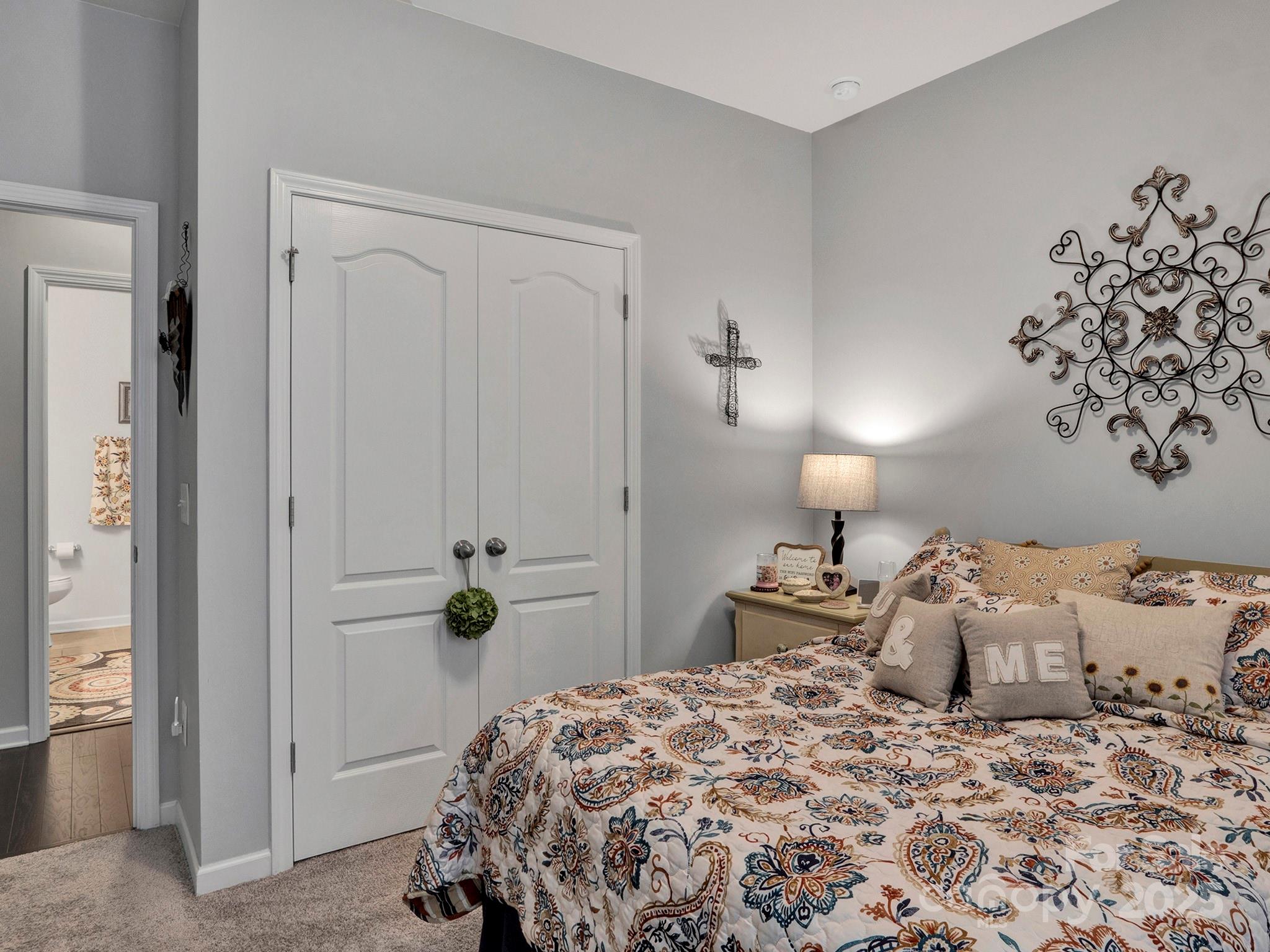 3129 Bridgewater Street, Unit 3E61 Lancaster, SC 29720 - Photo 26 of 48 a bedroom with a bed and a chandelier