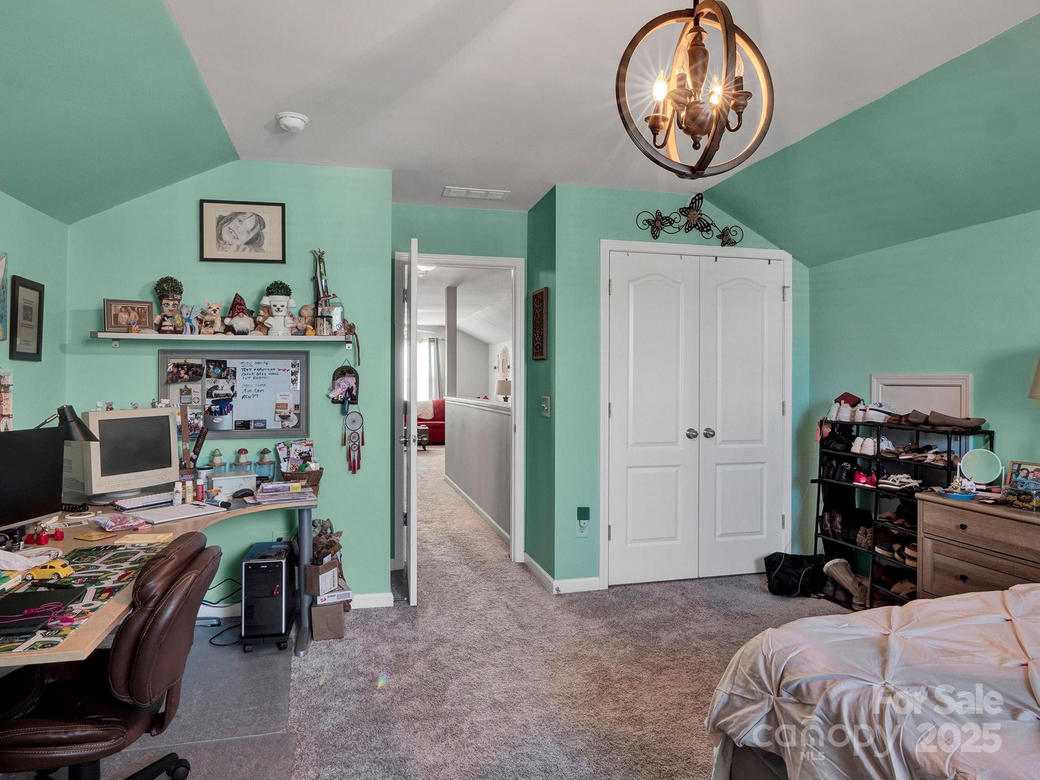 3129 Bridgewater Street, Unit 3E61 Lancaster, SC 29720 - Photo 37 of 48 a bedroom with a bed and a chandelier