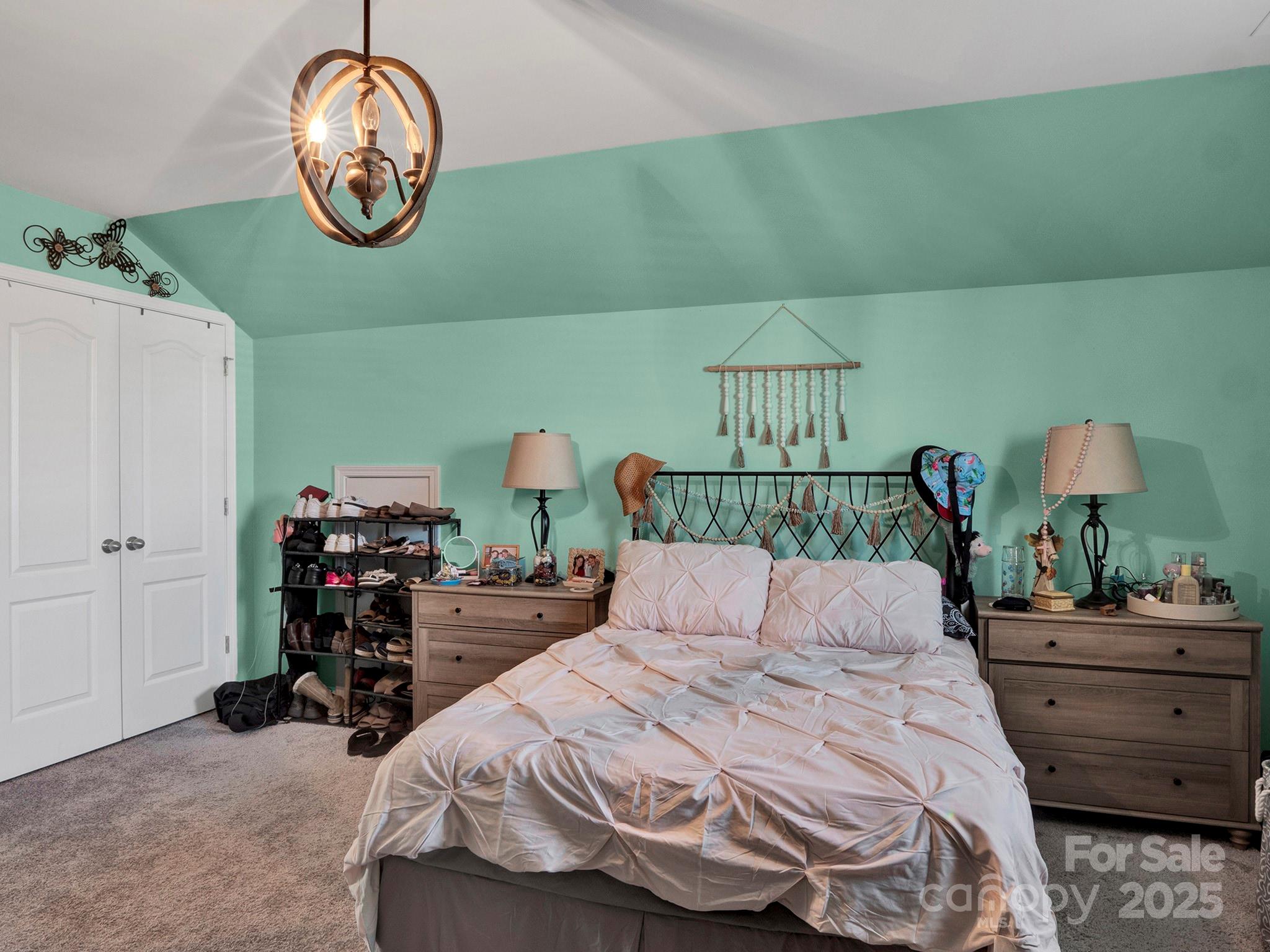 3129 Bridgewater Street, Unit 3E61 Lancaster, SC 29720 - Photo 38 of 48 a bedroom with bed and a chandelier