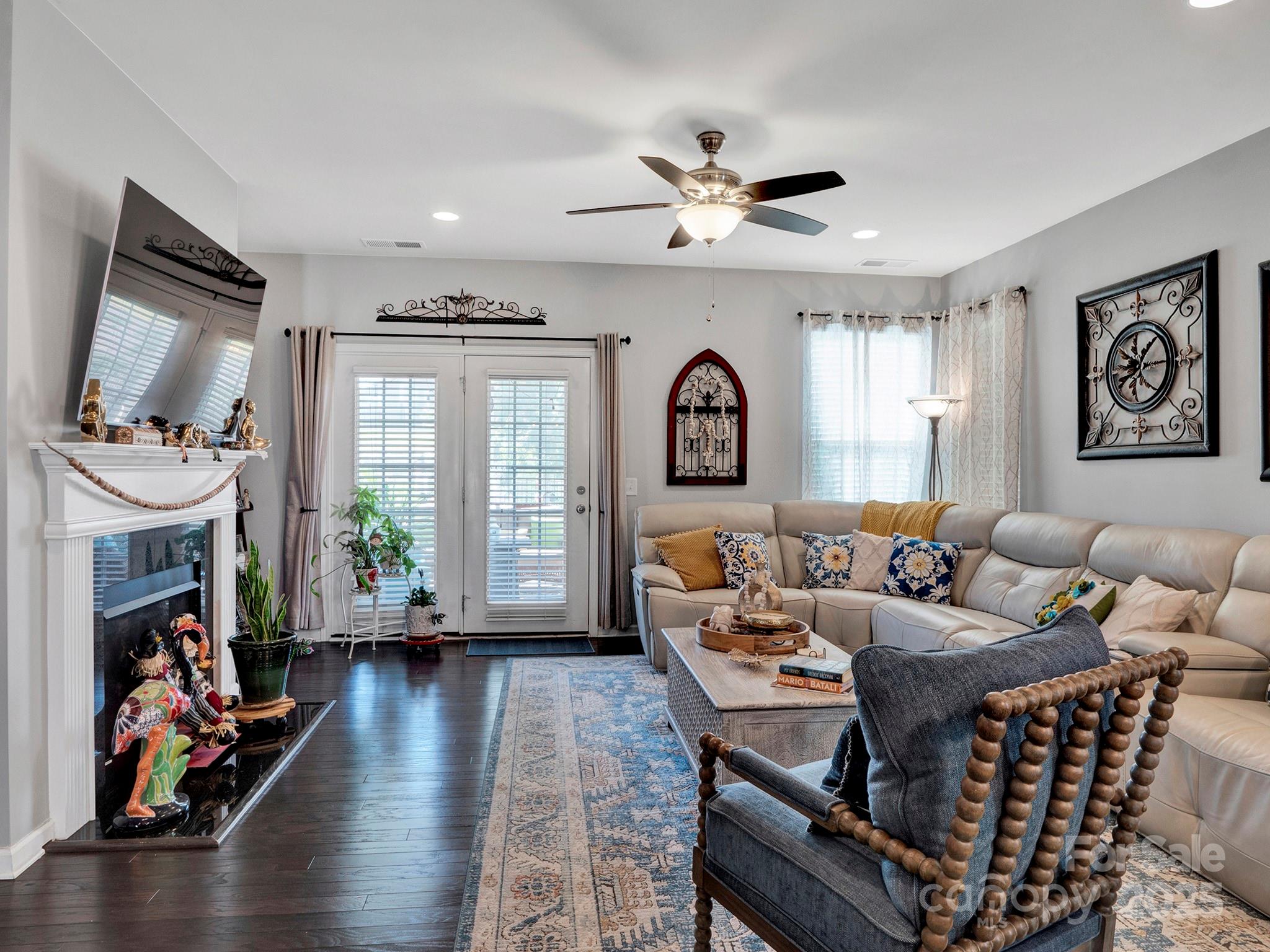3129 Bridgewater Street, Unit 3E61 Lancaster, SC 29720 - Photo 9 of 48 a living room with furniture a fireplace and a flat screen tv