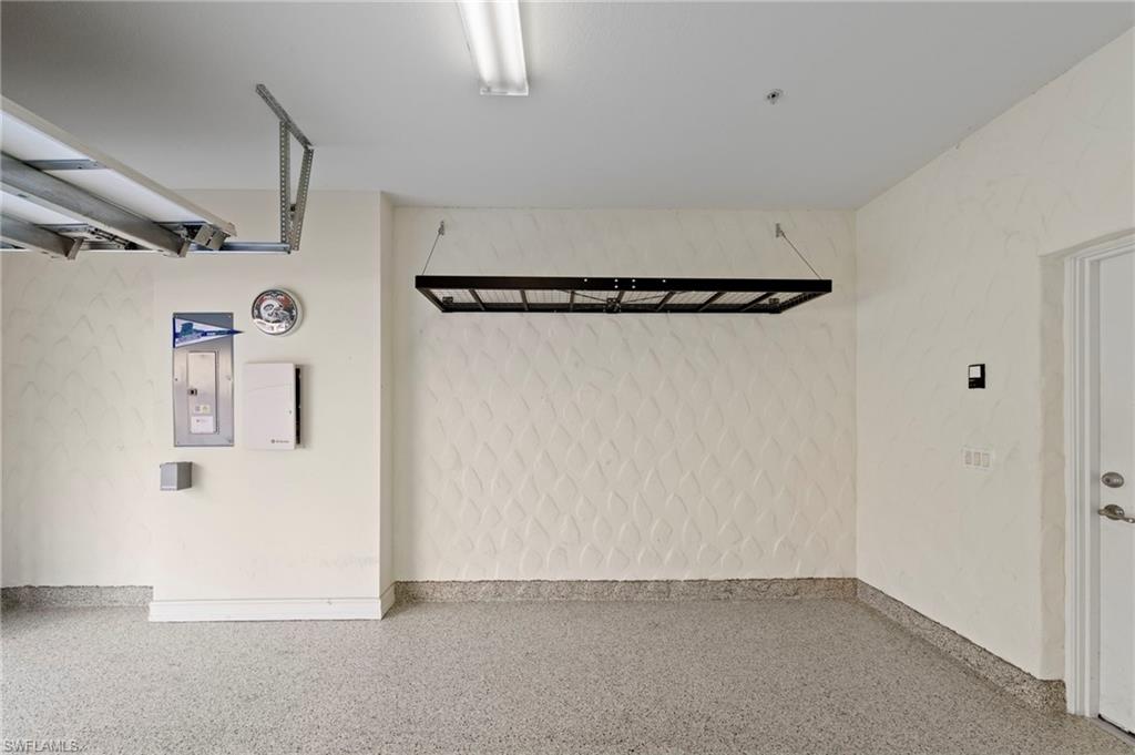 9076 Rialto Street, Unit 6204 Naples, FL 34113 - Photo 31 of 50 NEW DEDICATED GENERATOR OUTLET (2024), NEW HEAVY DUTY EPOXY FLOOR (2024), NEW HANGING STORAGE SHELVES (2021)