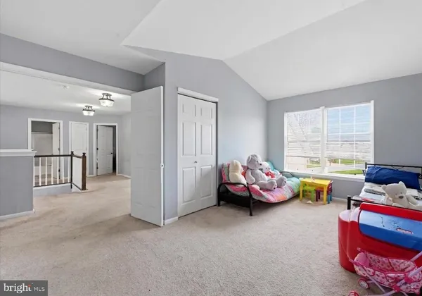 a bedroom with furniture and a window