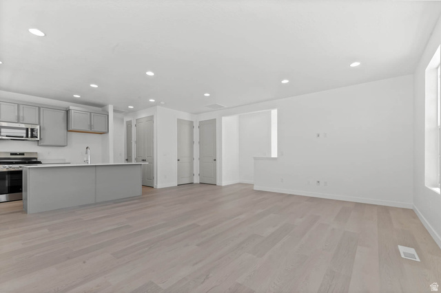 3204 West 1570 North Provo, UT 84601 - Photo 11 of 19 Kitchen with stainless steel appliances, recessed lighting, gray cabinets, light wood-style flooring, and light countertops