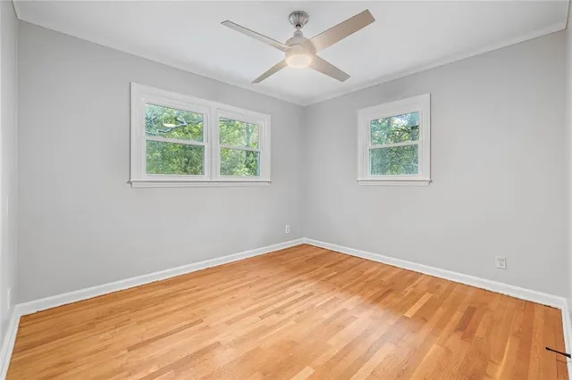 an aerial view of green landscape with trees houses and lake view