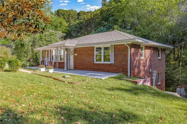 a view of a big room with wooden floor and windows