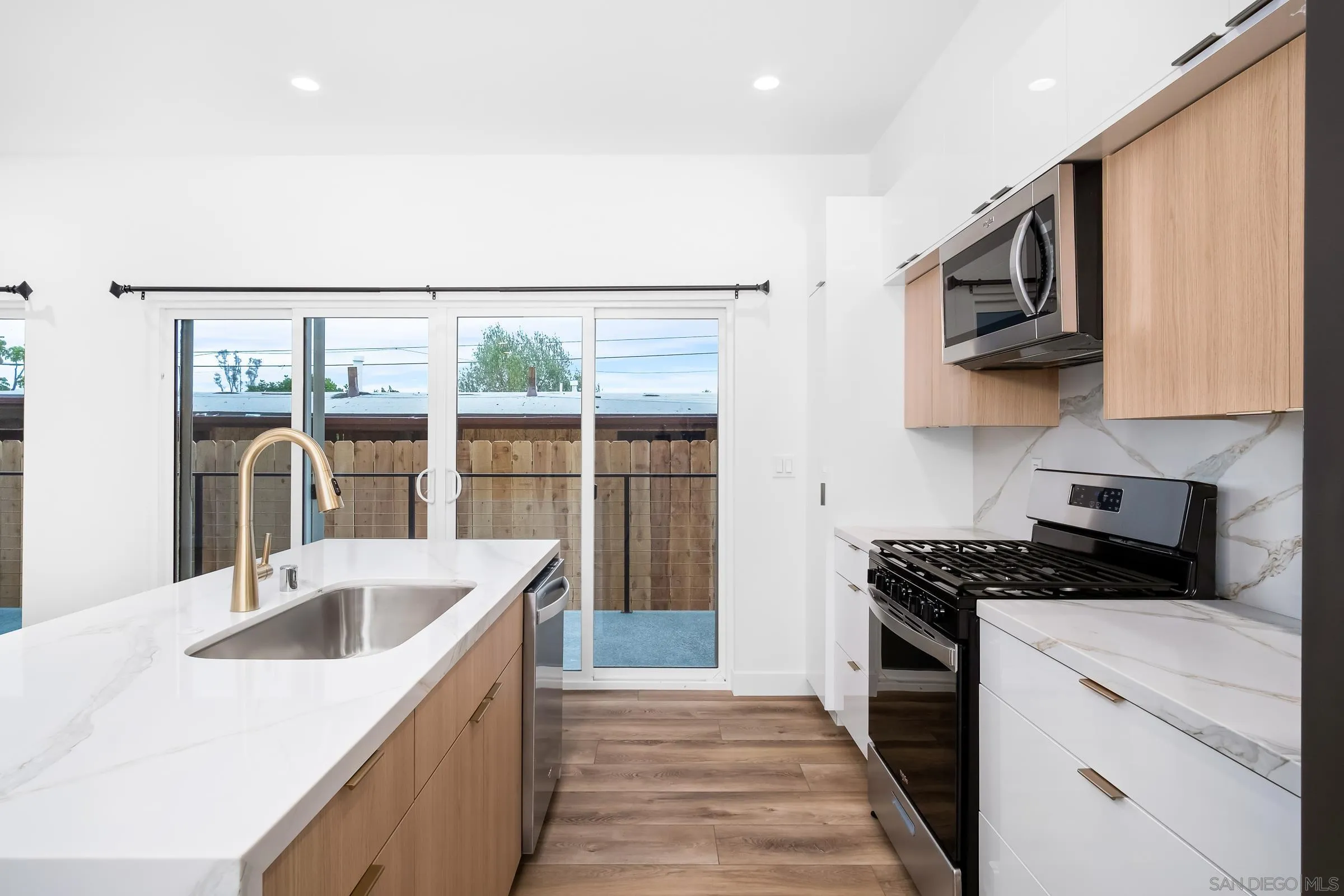 5230-32 Rincon Street San Diego, CA 92115 - Photo 11 of 29 a kitchen that has a sink and a stove